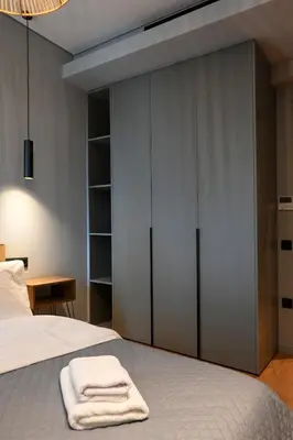 a bedroom with a bed with sliding glass doors at New 2BR apt in Kallithea in Athens