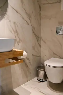 a bathroom with a white toilet and a sink at New 2BR apt in Kallithea in Athens