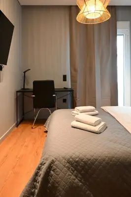 a bedroom with a bed with two towels on it at New 2BR apt in Kallithea in Athens