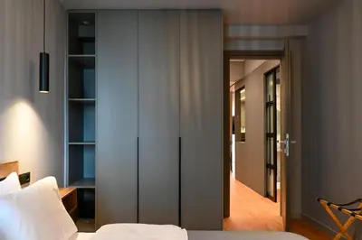 a bedroom with a bed and a door leading to a hallway at New 2BR apt in Kallithea in Athens