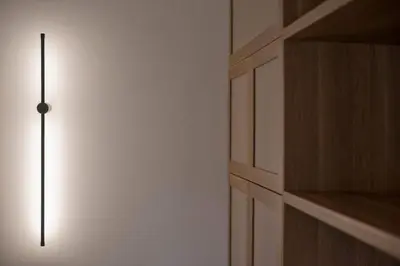 a light on a wall next to a closet at Asteria studio in Glyfada in Athens