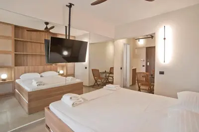 a bedroom with two beds and a flat screen tv at Asteria studio in Glyfada in Athens