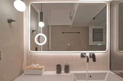 a bathroom with a sink and a mirror at Asteria studio in Glyfada in Athens