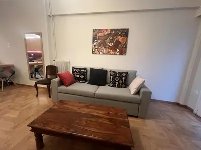 a living room with a couch and a table at Nelly's Athens Apartments in Athens