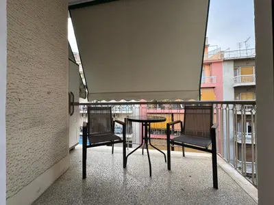a balcony with a table and two chairs at Nelly's Athens Apartments in Athens