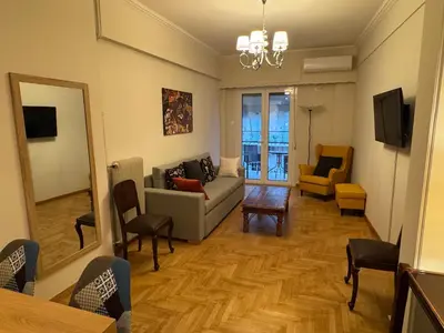 a living room with a couch and a table at Nelly's Athens Apartments in Athens