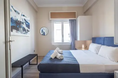 a bedroom with a bed with a teddy bear on it at Kastella Waves Chic 2-Bedroom Getaway in Piraeus