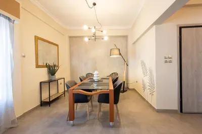 a dining room with a table and chairs at Kastella Waves Chic 2-Bedroom Getaway in Piraeus