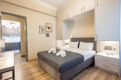 a bedroom with a bed with two pillows on it at Kastella Waves Chic 2-Bedroom Getaway in Piraeus