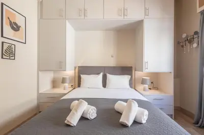 a bedroom with a bed with two pillows on it at Kastella Waves Chic 2-Bedroom Getaway in Piraeus