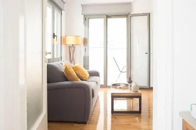 a living room with a couch and a table at Cosy Penthhouse with stunning view in Athens