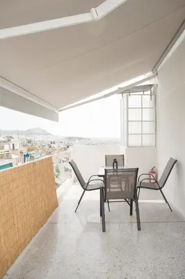 a dining room with a table and chairs on a balcony at Cosy Penthhouse with stunning view in Athens