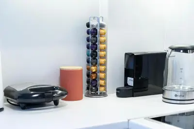 a kitchen counter with a toaster a blender and a microwave at Cosy Penthhouse with stunning view in Athens