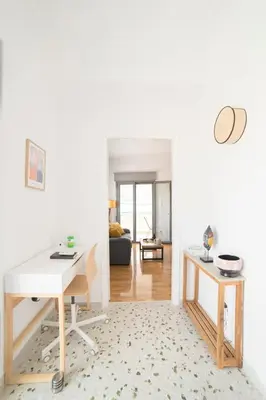 a living room with a desk and a couch at Cosy Penthhouse with stunning view in Athens