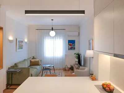 a living room with a couch and a table at Amanita Athens Iridanou apartment in Athens