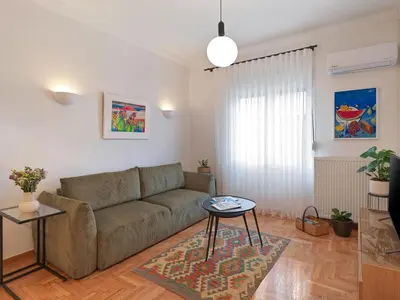 a living room with a couch and a table at Amanita Athens Iridanou apartment in Athens