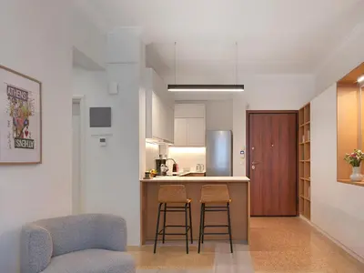 a kitchen with two chairs and a counter in a room at Amanita Athens Iridanou apartment in Athens