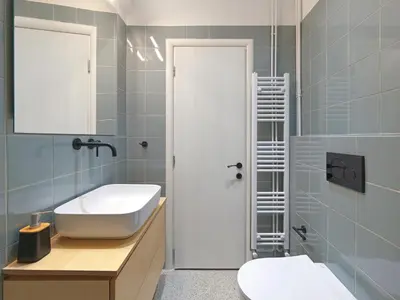 a bathroom with a sink and a toilet and a mirror at Amanita Athens Iridanou apartment in Athens
