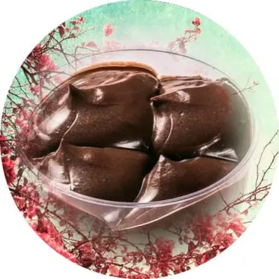 a bowl of chocolate on a plate with a spoon at Duffy Duck apartment athens in Athens