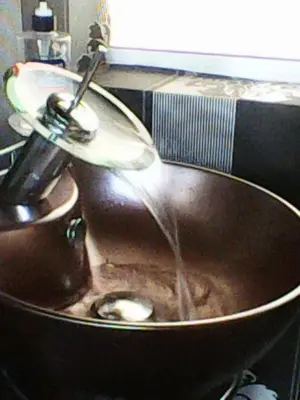a water fountain in a copper sink in a kitchen at Duffy Duck apartment athens in Athens