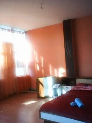 a bedroom with orange walls and a bed in it at Duffy Duck apartment athens in Athens