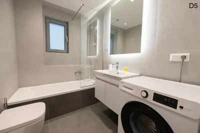 a bathroom with a sink and a washing machine at Waylink Residences - Marina Floisvou - Z4 in Athens
