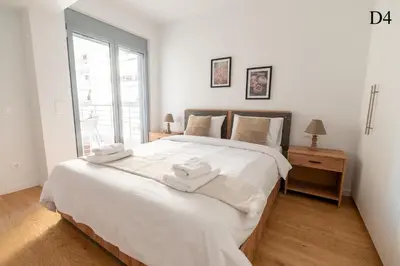a bedroom with a large white bed with towels on it at Waylink Residences - Marina Floisvou - Z4 in Athens