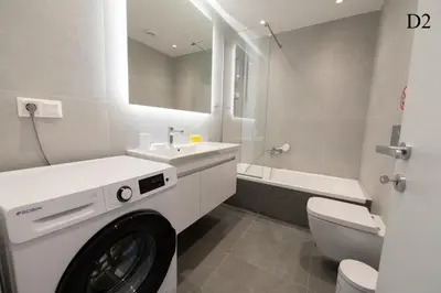 a washing machine in a bathroom with a sink and a toilet at Waylink Residences - Marina Floisvou - Z4 in Athens