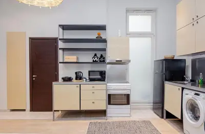 a kitchen with a stove and a washer and dryer at K8 Syntagma in Athens