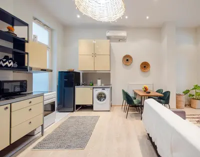 a kitchen and living room with a table and chairs at K8 Syntagma in Athens
