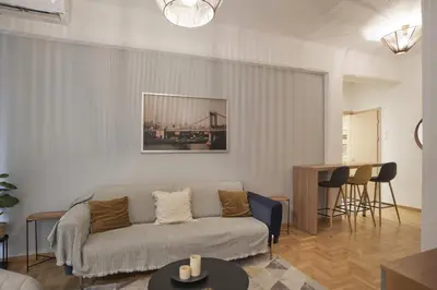 a living room with a couch and a table at Bellissimo Ctr Stylish Reno 2BR Apt near Acropolis in Athens