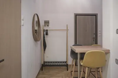 a dining room with a table and chairs and a mirror at Bellissimo Ctr Stylish Reno 2BR Apt near Acropolis in Athens