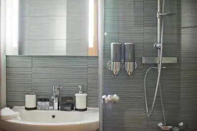 a bathroom with a sink and a shower at Bellissimo Ctr Stylish Reno 2BR Apt near Acropolis in Athens