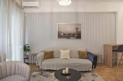 a living room with a couch and a table at Bellissimo Ctr Stylish Reno 2BR Apt near Acropolis in Athens