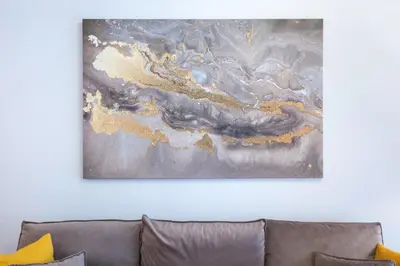 a painting on a wall above a couch at Modern Apartment near City center in Athens