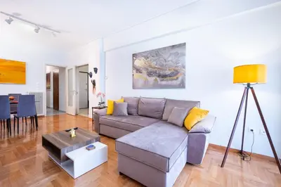 a living room with a couch and a table at Modern Apartment near City center in Athens