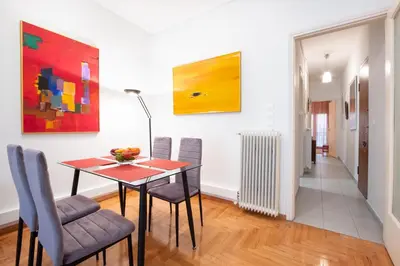 a dining room with a table and chairs at Modern Apartment near City center in Athens