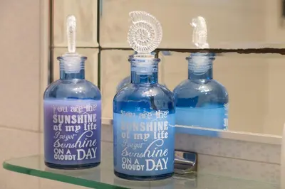 two bottles of water on a shelf in a bathroom at Modern Apartment near City center in Athens