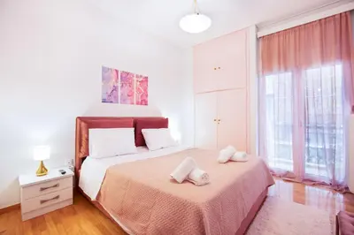 a bedroom with a bed with two towels on it at Modern Apartment near City center in Athens