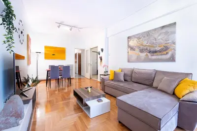 a living room with a couch and a table at Modern Apartment near City center in Athens
