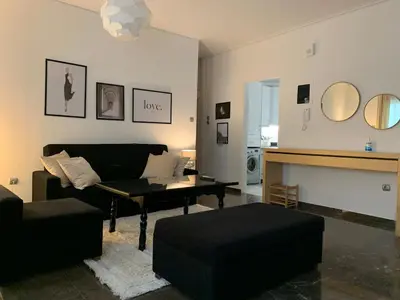 a living room with a couch and a table at Quiet apartment in Athens