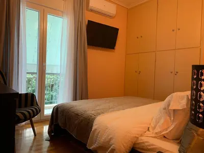 a bedroom with a bed and a window at Quiet apartment in Athens