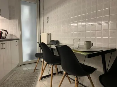 a kitchen with a table and chairs in a kitchen at Quiet apartment in Athens