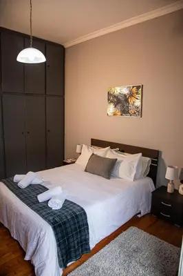 a bedroom with a large bed with towels on it at Stephan's Modern Apartment in Athens
