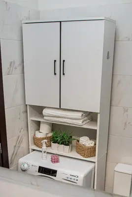 a white cabinet in a bathroom with a white refrigerator at Stephan's Modern Apartment in Athens