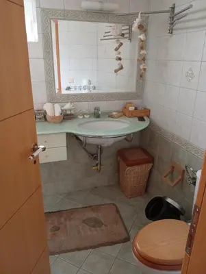 a bathroom with a sink and a toilet at Cosy garden house in a villa in Palaiá Fókaia