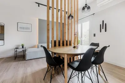 a dining room with a wooden table and black chairs at Brisk - Chic 1 Bedroom Apartment in Athens in Athens