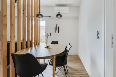 a dining room with a wooden table and chairs at Brisk - Chic 1 Bedroom Apartment in Athens in Athens