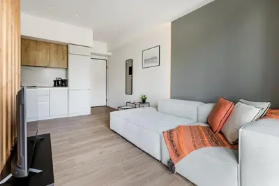 a living room with a couch and a kitchen at Brisk - Chic 1 Bedroom Apartment in Athens in Athens
