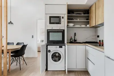 a kitchen with a washing machine and a microwave at Brisk - Chic 1 Bedroom Apartment in Athens in Athens